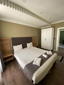 a bedroom with a large bed with two pillows on it at Centrum Hotel in Ankara