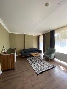 a living room with a couch and a table at Centrum Hotel in Ankara