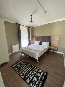 a bedroom with a large bed and a rug at Centrum Hotel in Ankara