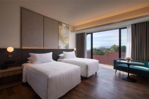 PARKROYAL Langkawi Resort客房内的一张或多张床位