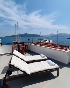 a boat with two benches and a table on the deck at Vista House Marmaris in Marmaris