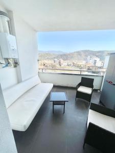 a room with a white couch and chairs and a table at Suite Rooms in Cosenza