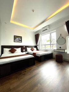 Postel nebo postele na pokoji v ubytování King Hotel Da Nang