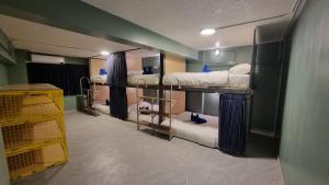 a room with three bunk beds in it at Glur Hostel Pattaya Walking Street in Pattaya Central