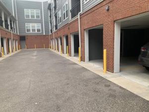 an empty parking lot next to a brick building at A Cozy /Luxury One bedroom in Downtown Indy in Indianapolis