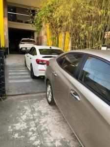 two parked cars parked in a parking lot at Ngoc Kha Tu 2 Hotel in Long Xuyên