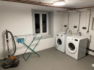 a laundry room with a washing machine and a washer at homy Central City Oasis in Dornbirn in Dornbirn