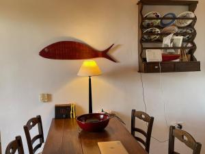 a dining room table with a fish head on the wall at Villa LA FAMILIA maison traditionnelle in Plakias
