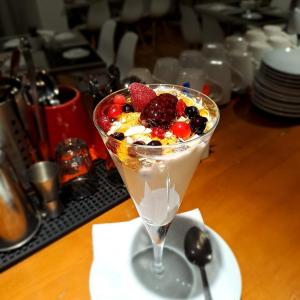 a dessert with fruit in a martini glass on a table at La Veranda Hotel in Larnaca
