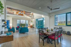 een eetkamer en een woonkamer met een tafel en stoelen bij StayVista at Colour Bloom - Pet Friendly Home with Swimming Pool 