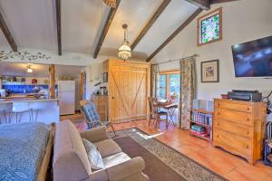 a living room with a couch and a kitchen at Cozy Story Book Barn Cottage with Scenic View in Julian