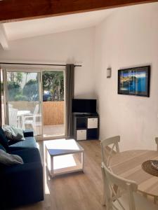 a living room with a blue couch and a table at Charming 1 bedroom flat, Biarritz center with pool and car park in Biarritz
