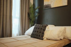a bed with a pillow sitting on top of it at Modern Minimalist 1 BR Condo in IT Park in Cebu City