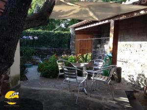 La casa di Sergio في Bauladu: طاولة وكراسي تحت مظلة على الفناء