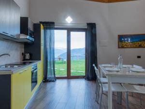 a kitchen with a table and a dining room at Agriturismo Baita Bavè in San Fedele Superiore