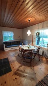 a living room with a table and chairs and a couch at Mökki Kainula in Veteli