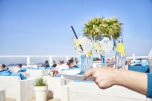 a person holding a table with glasses on the beach at Knokke Sea, Appartement Vue mer in Knokke-Heist