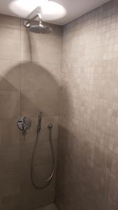 a shower with a shower head in a bathroom at Knokke Sea, Appartement Vue mer in Knokke-Heist +38 photos
