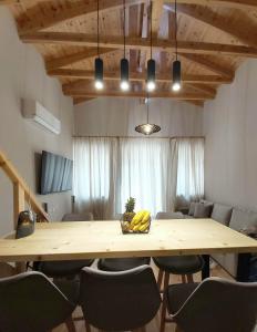 a large wooden table with chairs in a room at SITIA CITY CENTER luxury apartment in Sitia