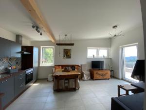 a kitchen with a table in the middle of a room at Haus Lannachberg in Lannach