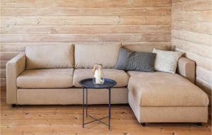 a living room with a couch and a table at Stunning Home In Farsund With Wifi in Farsund
