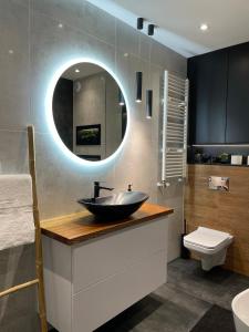 a bathroom with a sink and a mirror at No 59 Apartament in Nowy Targ
