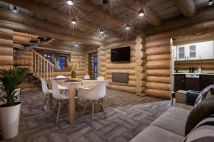 a dining room with wooden walls and a table and chairs at Apartel Villa Shayan in Shaian