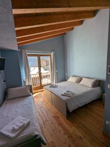 a bedroom with a large bed and a balcony at CONSTANCIA TRATTORIA in Valdieri