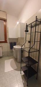 a bathroom with a sink and a shelf in it at Sweet Home in Garbagnate Milanese +8 photos