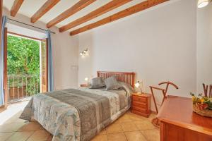 a bedroom with a bed and a table and a window at Casa Fortuny in Soller in Sóller