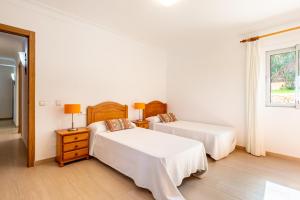 A bed or beds in a room at Villa Cas Puig - Beach of Portinatx