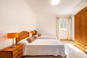 A bed or beds in a room at Villa Cas Puig - Beach of Portinatx