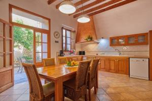 a large kitchen with a wooden table and chairs at Casa Fortuny in Soller in Sóller