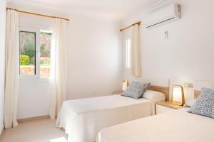 A bed or beds in a room at Villa Cas Puig - Beach of Portinatx