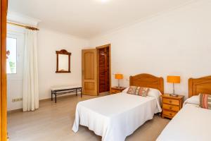 A bed or beds in a room at Villa Cas Puig - Beach of Portinatx