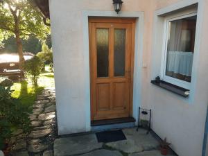 a wooden door on the side of a house at Penzion Montana in Nýrsko