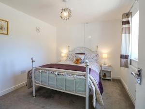 a bedroom with a bed and a chandelier at Bear Lake Lodge in Alderwasley