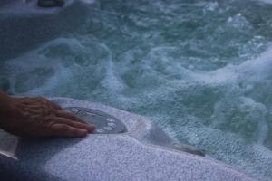 a person holding a remote control in a pool of water at Alaudy Vacances Séjours écologiques - 2 gites in Ossages +76 photos
