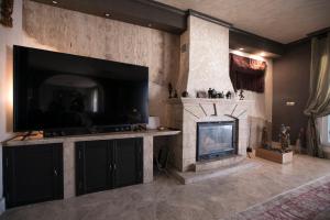 a living room with a fireplace and a flat screen tv at Chalet asosado in Almerimar