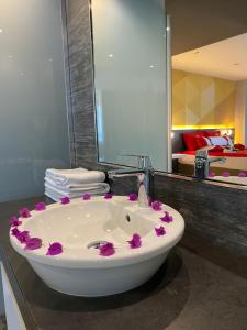 a bathroom with a sink with purple flowers on it at Bosphorus Sorgun Hotel in Side