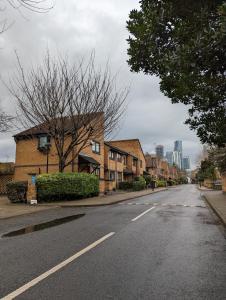 an empty street with buildings on the side of the road at Cosy house with a garden in London