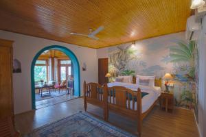 a bedroom with a bed with a painting on the wall at Seclude Nahan, Bantony Cottage in Nāhan