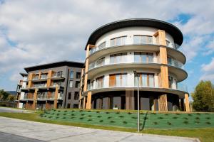 a large apartment building with a round at SKi&bike apartments Laguna Zarzecze in Zarzecze