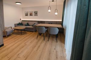 a living room with a couch and a table and chairs at Winkler Appartements in Saalbach Hinterglemm