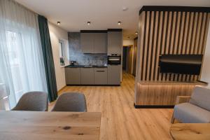 a kitchen with a table and chairs in a room at Winkler Appartements in Saalbach Hinterglemm