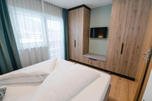 a small bedroom with a bed and a window at Winkler Appartements in Saalbach Hinterglemm