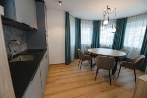 a kitchen and dining room with a table and chairs at Winkler Appartements in Saalbach Hinterglemm