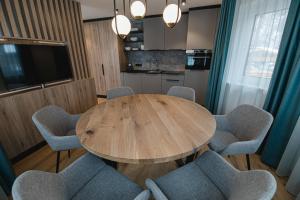 a dining room with a wooden table and chairs at Winkler Appartements in Saalbach Hinterglemm