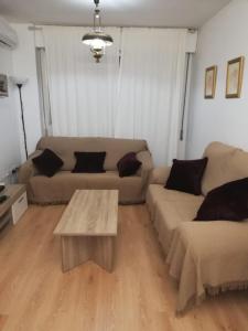 a living room with a couch and a coffee table at NUEVA VIVIENDA/APARTAMENTO COMPLETO EN SEVILLA in Seville