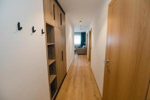 a hallway with wooden shelves and a door at Winkler Appartements in Saalbach Hinterglemm